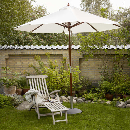 Catania Umbrella by Skagerak, showing umbrella with base, lounge chair and stool in live shot.