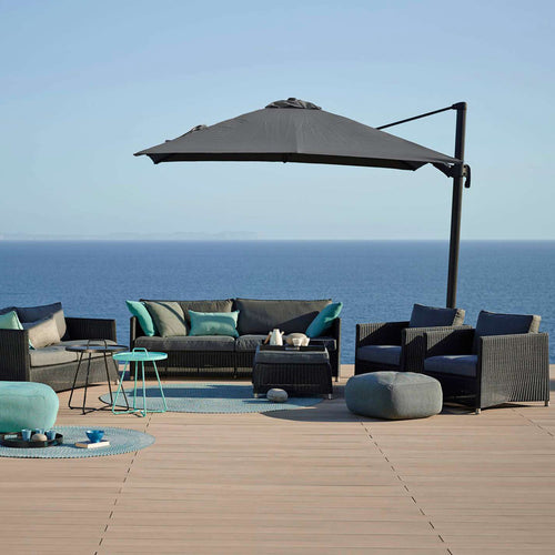 Hyde Luxe Parasol by Cane-Line, showing hyde luxe parasol with sofa, chairs & tables in live shot.