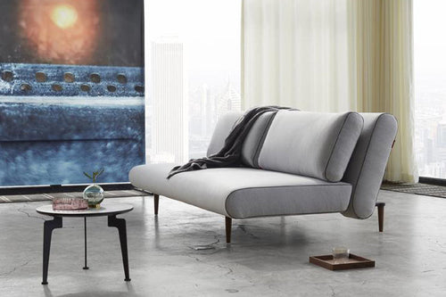 Unfurl Lounger Sofa Bed by Innovation, showing unfurl lounger sofa bed with table in live shot.
