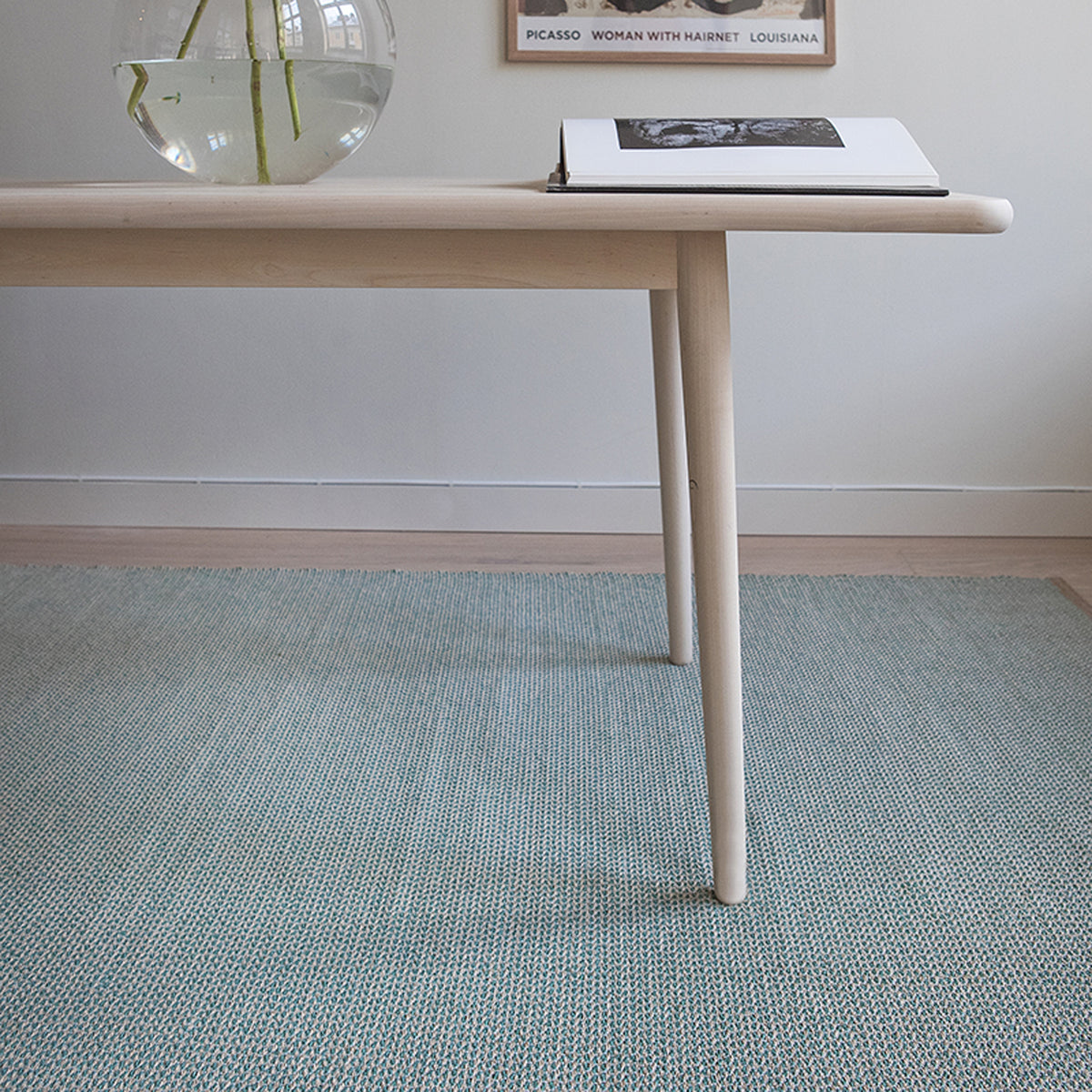 Benny Woven Plastic Rug by Brita, showing benny woven plastic rug in live shot.