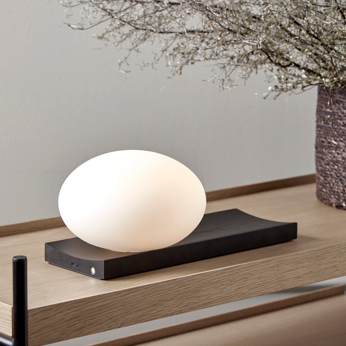 Dew Table/Wall Lamp by Woud, showing dew table/wall lamp in live shot.