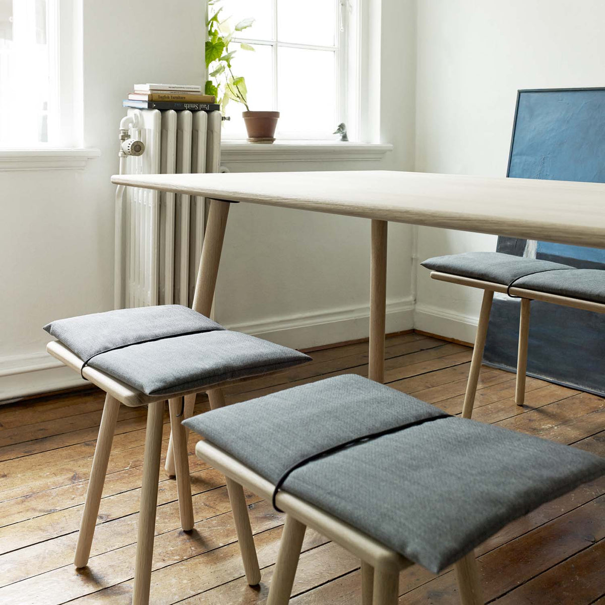 Georg Dining Table by Fritz Hansen, showing georg dining table in live shot.