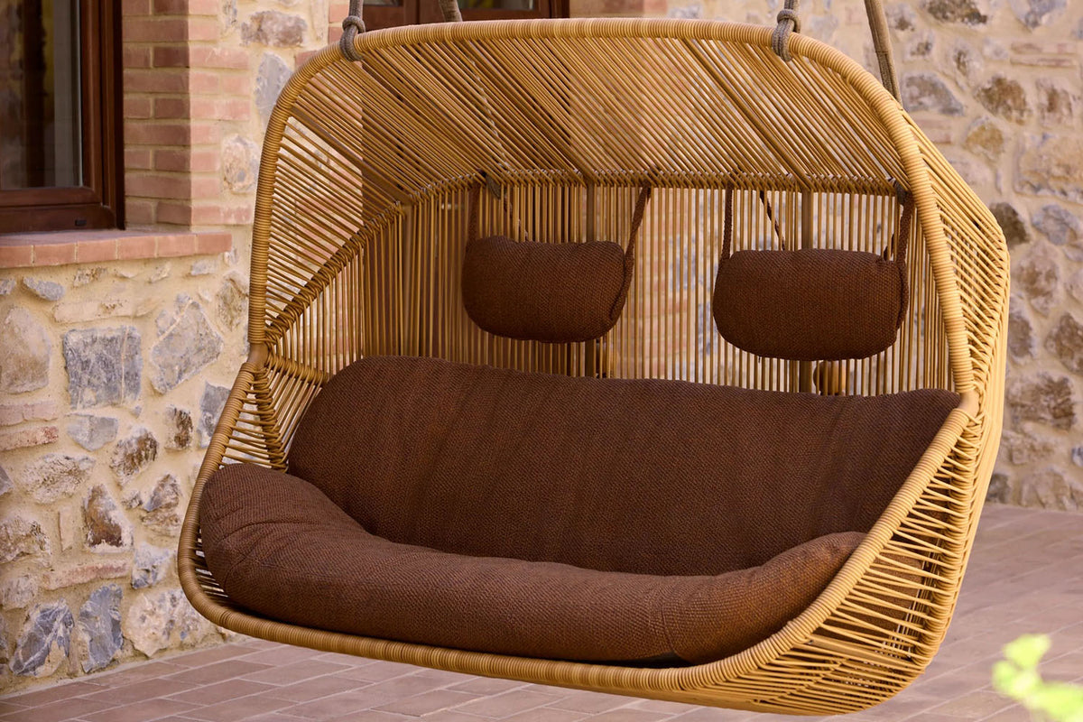 Hive 2-Seater Hanging Sofa With Rope by Cane-Line, showing hive 2-seater hanging sofa with rope in live shot.