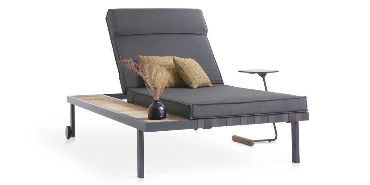 Albatross Sunbed with Side Tray by Mamagreen, showing angle view of albatross sunbed with side tray in iron black ultra durable stainless steel/cocoa keops webbing/performance textiles (grade a)/teak.