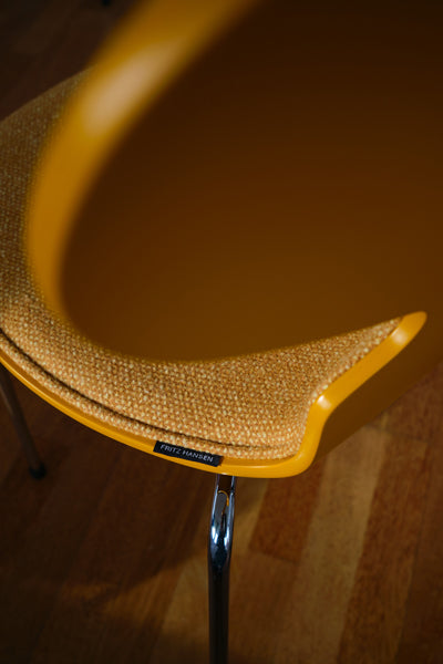 Ant Front Upholstery Chair by Fritz Hansen, showing closeup view of ant front upholstery chair in live shot.