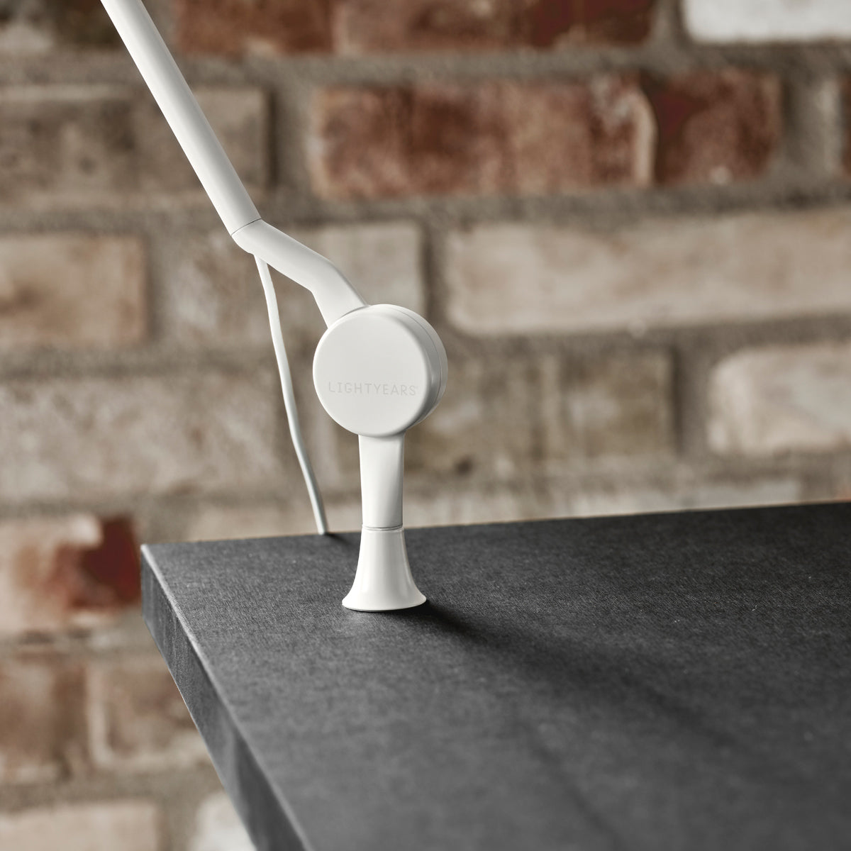AQ01 Table Lamp by Fritz Hansen, showing closeup view of aq01 table lamp in live shot.