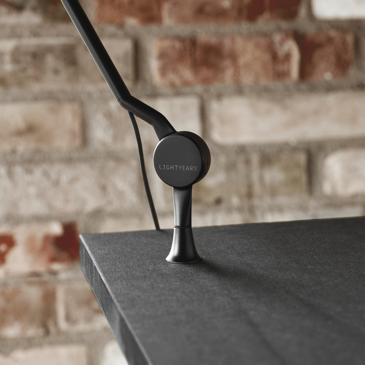 AQ01 Table Lamp by Fritz Hansen, showing closeup view of aq01 table lamp in live shot.