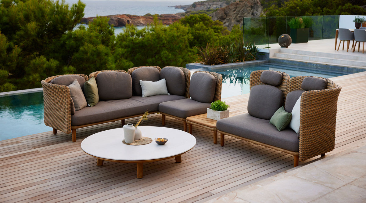 Arch Coffee Table by Cane-Line, showing arch coffee table in live shot.