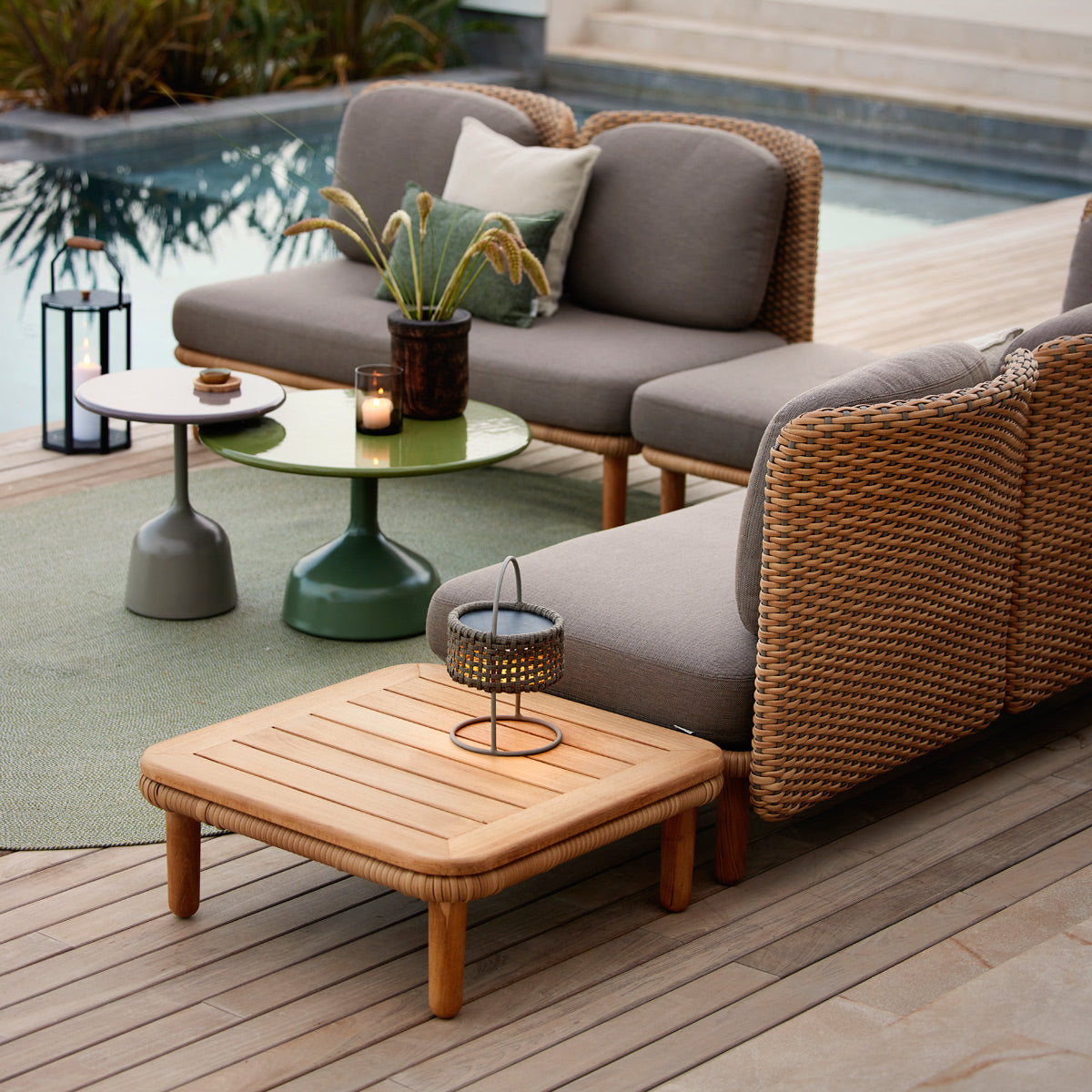 Arch Coffee Table by Cane-Line, showing arch coffee table in live shot.