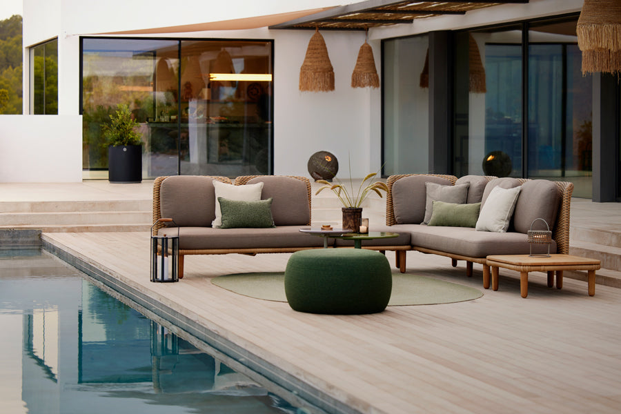Arch Coffee Table by Cane-Line, showing arch coffee table in live shot.