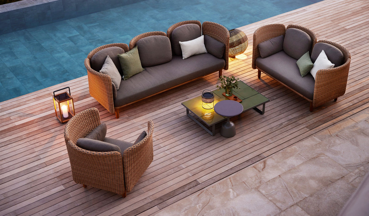 Arch Lounge Chair by Cane-Line, showing arch lounge chair in live shot.