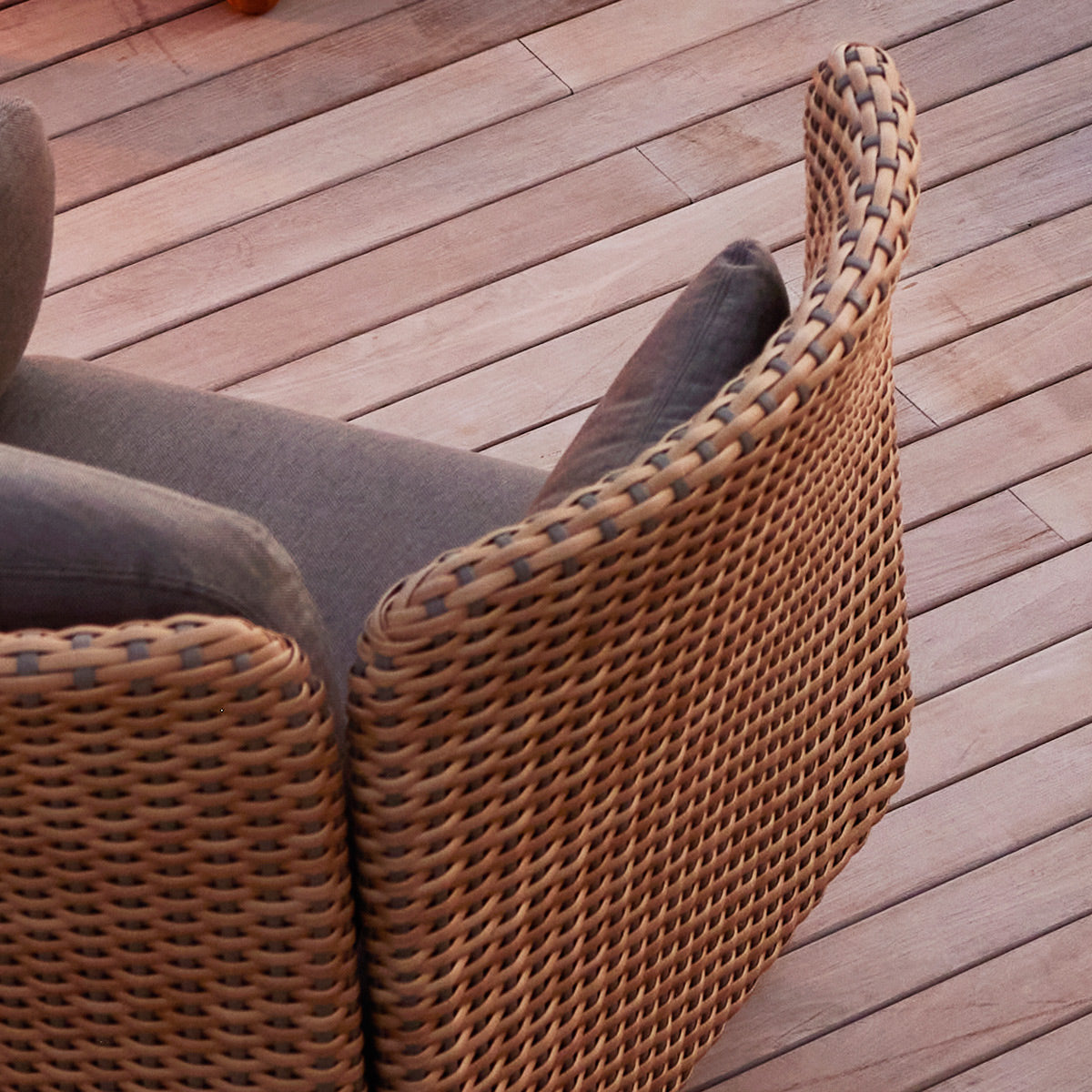 Arch Lounge Chair by Cane-Line, showing closeup view of arch lounge chair in live shot.