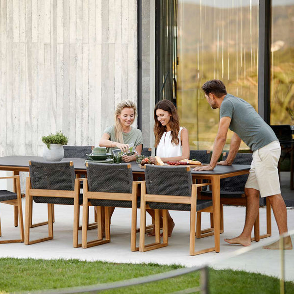Aspect Outdoor Dining Table by Cane-Line, showing aspect outdoor dining table with chairs in live shot.
