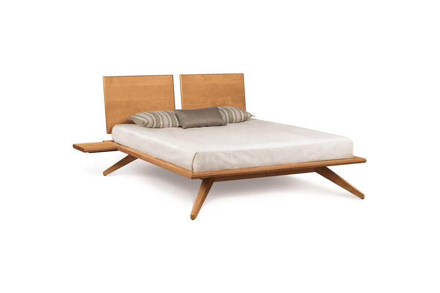 Astrid Nightstand by Copeland Furniture, showing angle view of astrid nightstand in shelf (left/right)/natural cherry with bed.