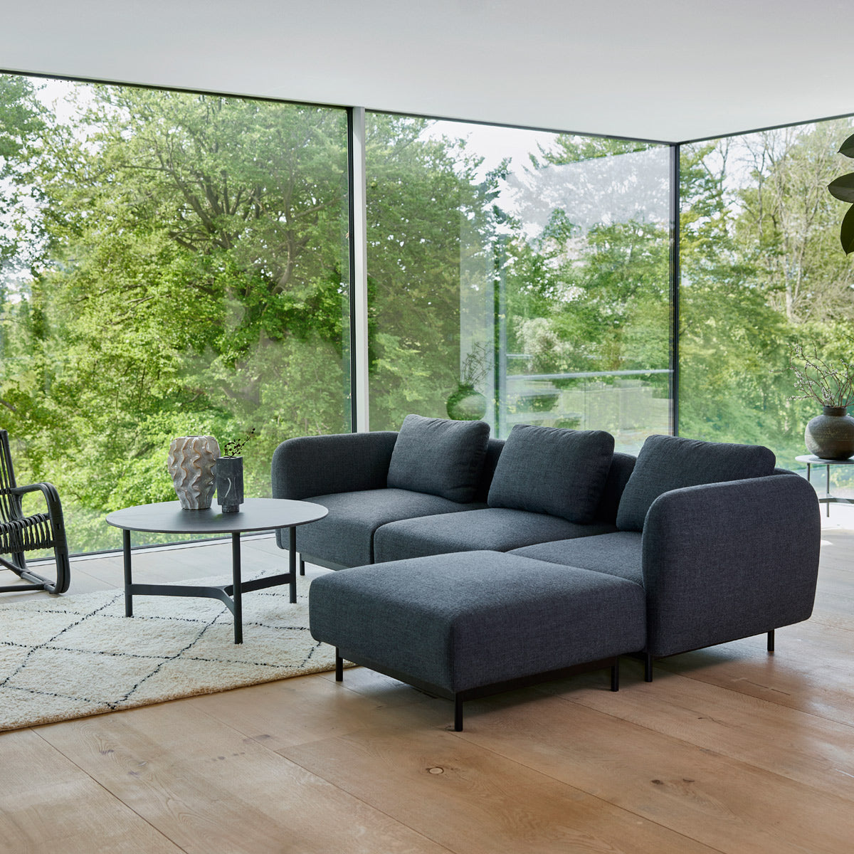Aura pouf by Cane-Line, showing aura pouf in live shot.
