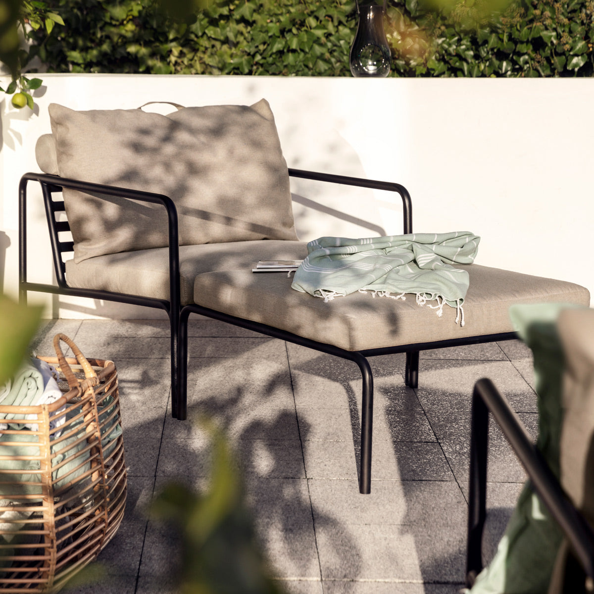 Avon Outdoor Ottoman by Houe, showing avon outdoor ottoman in live shot.
