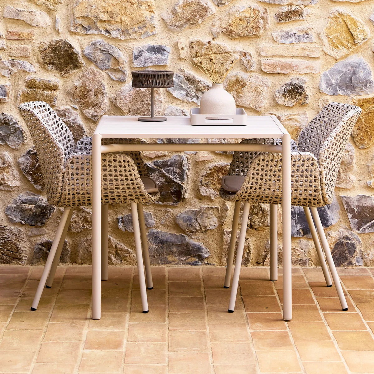 Bliss Dining Table by Cane-Line, showing bliss dining table in live shot.