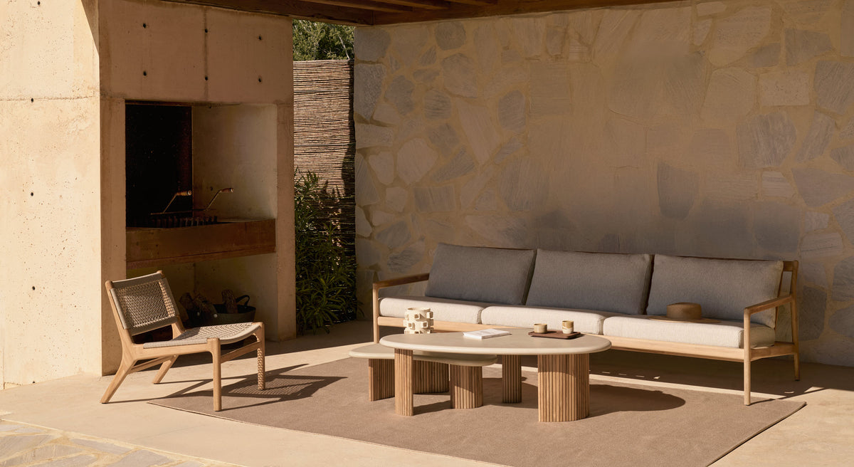 Boomerang Outdoor Coffee Table by Ethnicraft, showing boomerang outdoor coffee tables in live shot.