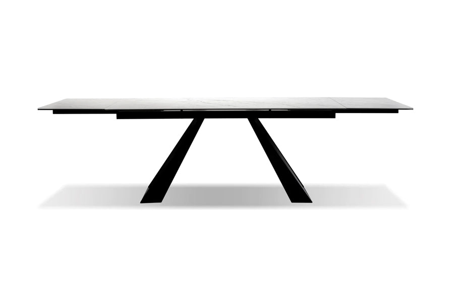 Bridge Extending Dining Table by Mobital, showing front view of bridge extending dining table in white carrera ceramic/black powder coated base.