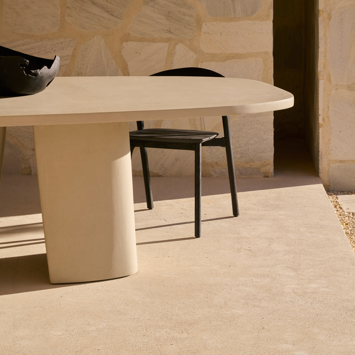 Canyon Outdoor Dining Table by Ethnicraft, showing closeup view of canyon outdoor dining table in live shot.