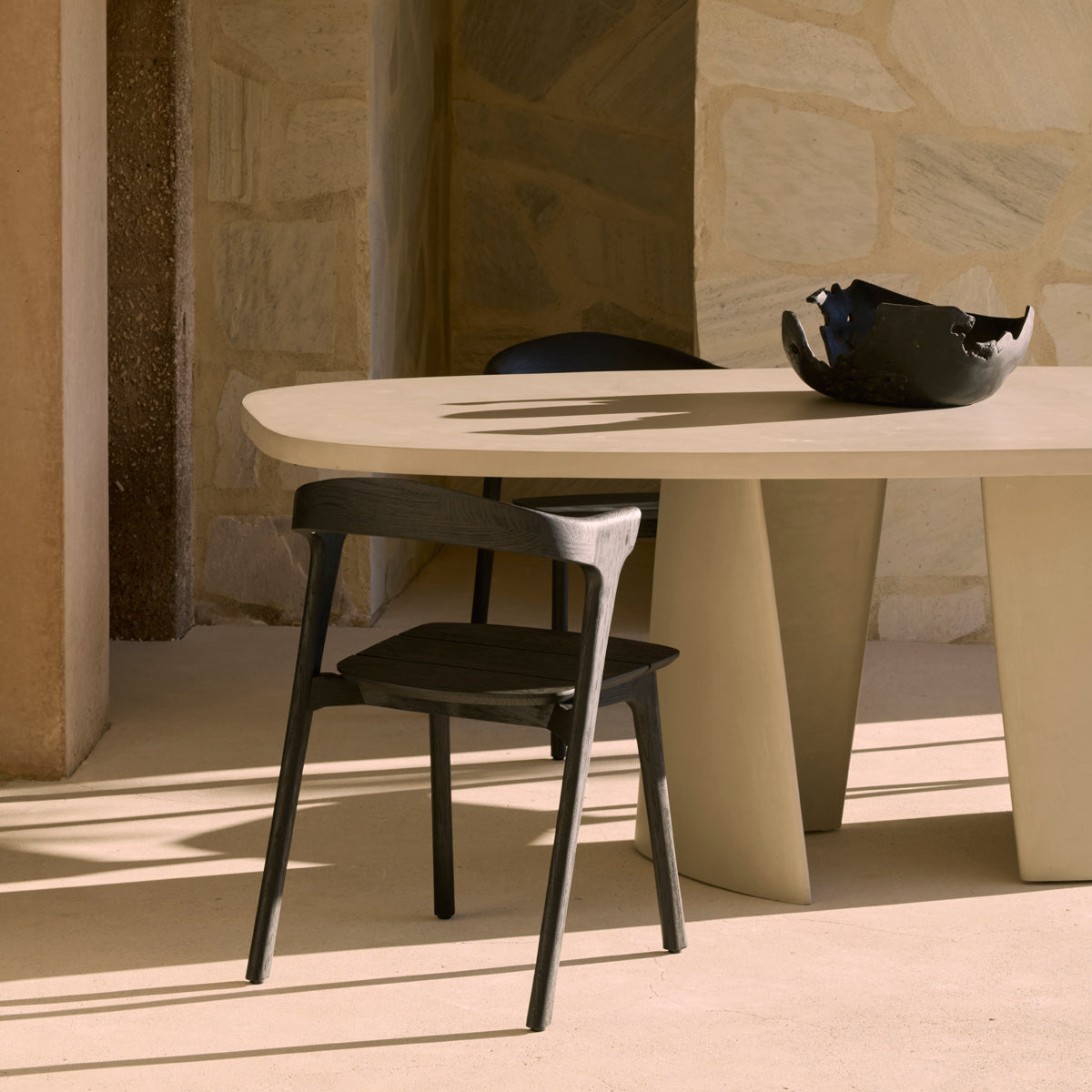 Canyon Outdoor Dining Table by Ethnicraft, showing closeup view of canyon outdoor dining table in live shot.