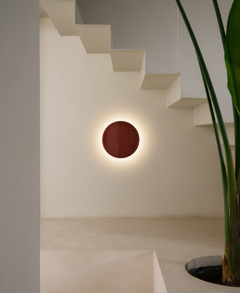 Caramel Wall Lamp by Marset, showing caramel wall lamp in live shot.