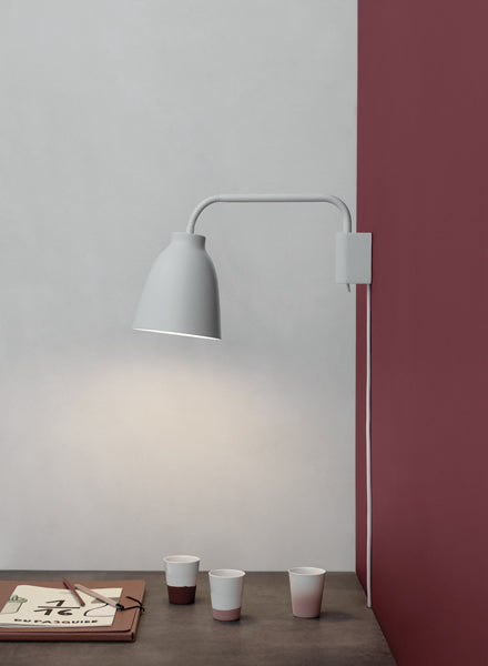 Caravaggio Wall Lamp by Fritz Hansen, showing caravagio wall lamp in live shot.