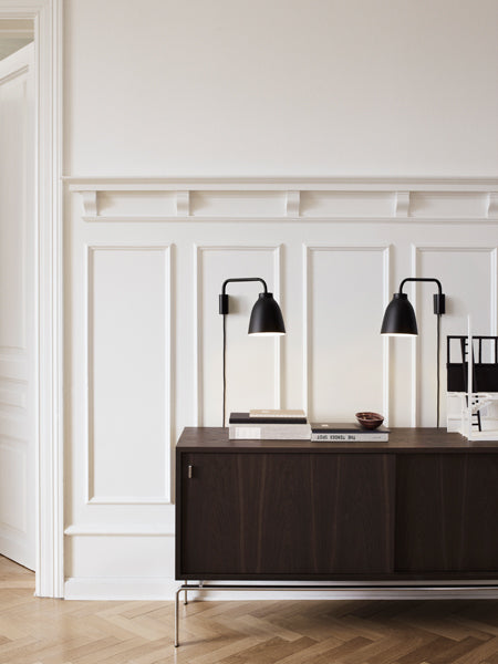 Caravaggio Wall Lamp by Fritz Hansen, showing caravagio wall lamps in live shot.