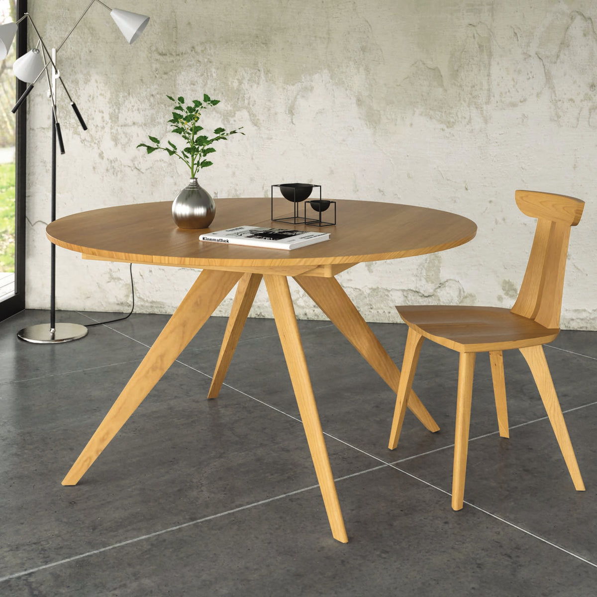 Catalina Round Extension Dining Table by Copeland Furniture, showing catalina round extension dining table with chair in live shot.