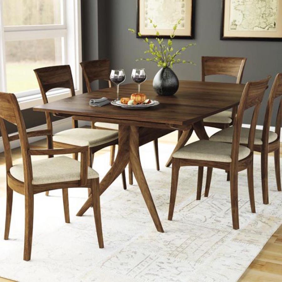 Catalina Trestle Extensions Table by Copeland Furniture, showing catalina trestle extensions table with chair in live shot.