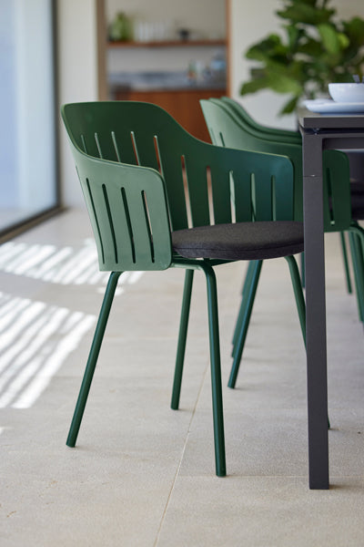 Choice 4 Legs Dark Green Steel Chair by Cane-Line, showing choice 4 legs dark green steel chairs in live shot.