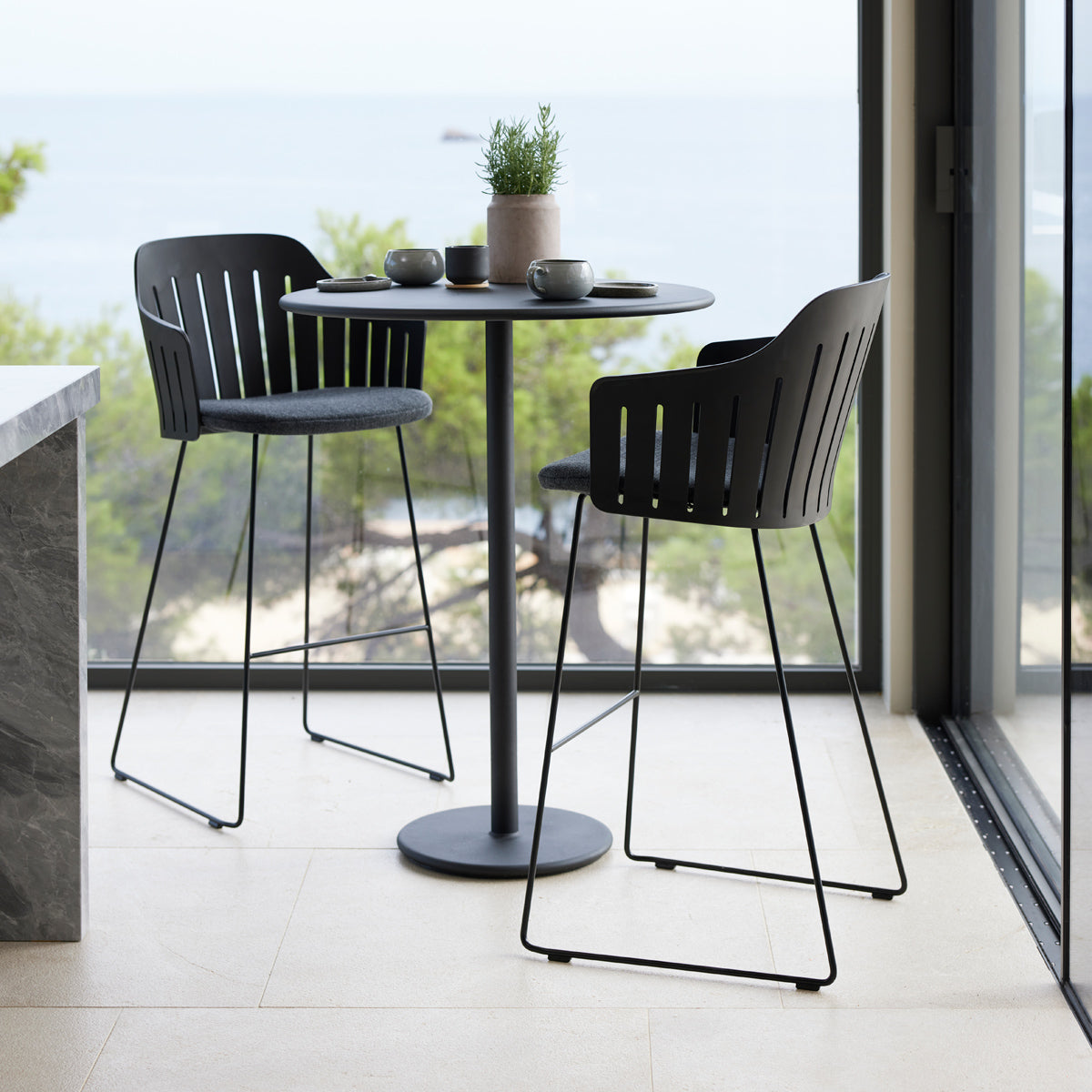 Choice Sled Bar Chair by Cane-Line, showing choice sled bar chairs in live shot.