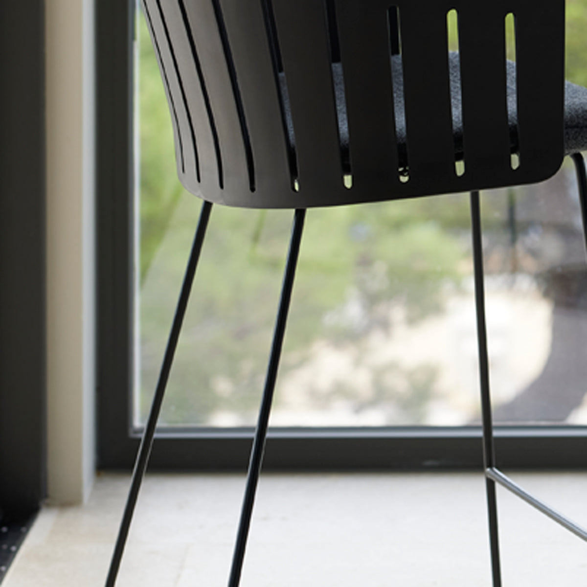 Choice Sled Bar Chair by Cane-Line, showing closeup view of choice sled bar chair in live shot.
