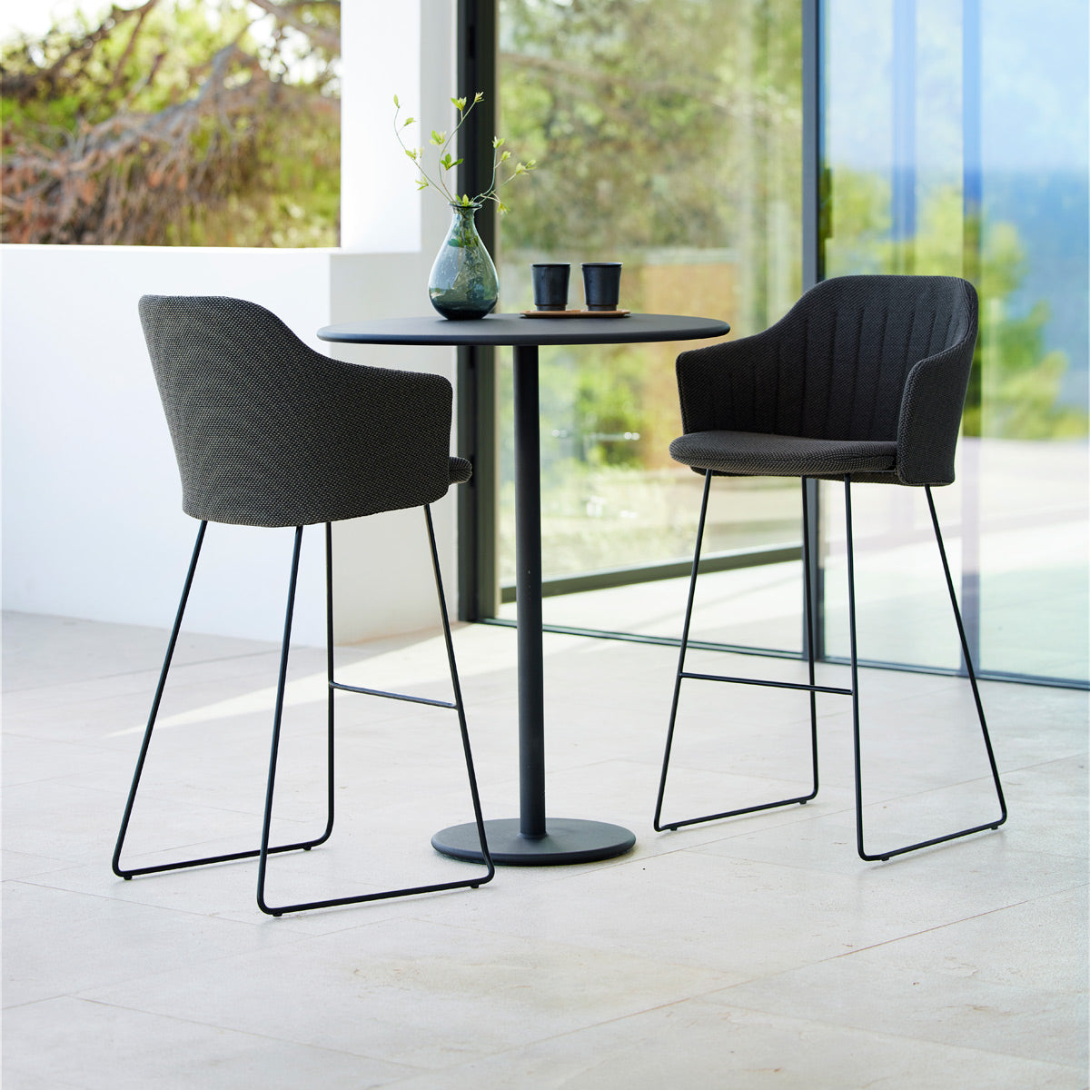 Choice Sled Outdoor Bar Chair by Cane-Line, showing choice sled outdoor bar chairs in live shot.