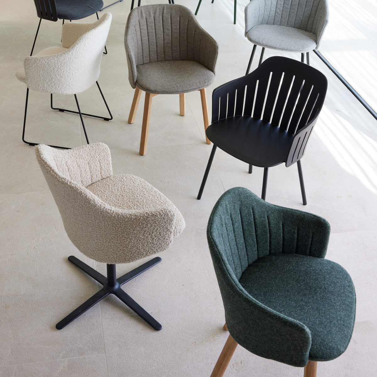 Choice Swivel Chair by Cane-Line, showing choice swivel chair in live shot.