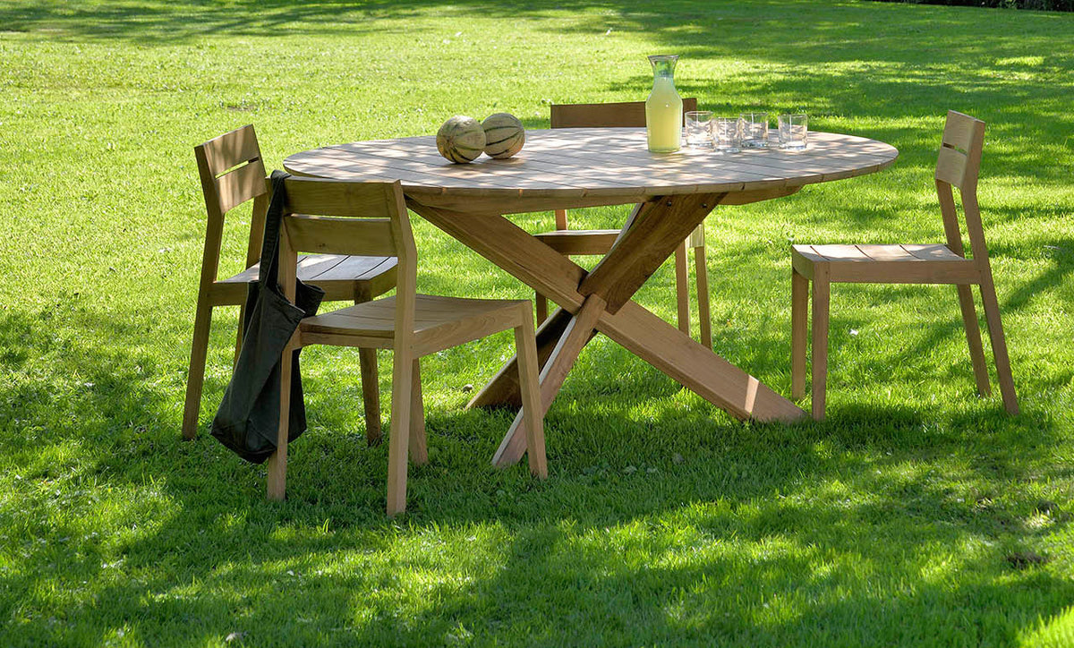 Circle Dining Table by Ethnicraft, showing circle dining table with chairs in the live shot.