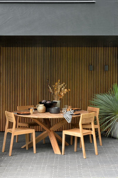 Circle Dining Table by Ethnicraft, showing cirlcle dining table with chairs in the live shot.