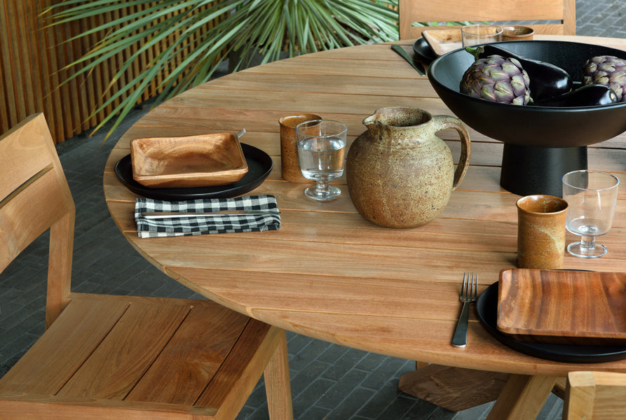 Circle Dining Table by Ethnicraft, showing closeup view of circle dining table with chairs in the live shot.