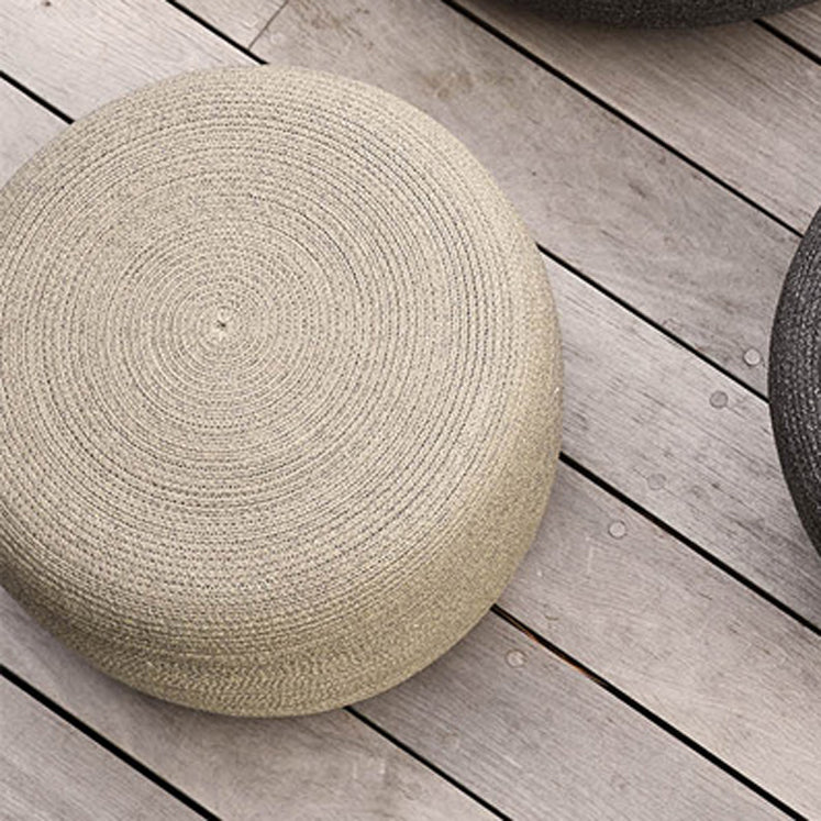 Circle Footstool by Cane-Line, showing closeup view of circle footstools in live shot.