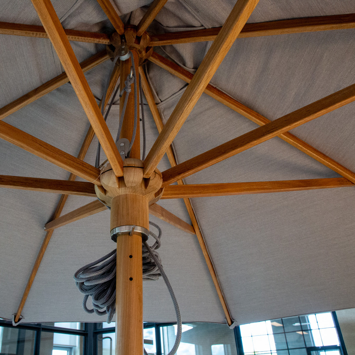 Classic Parasol with Pulley System by Cane-Line, showing closeup view of classic parasol with pulley system in live shot.