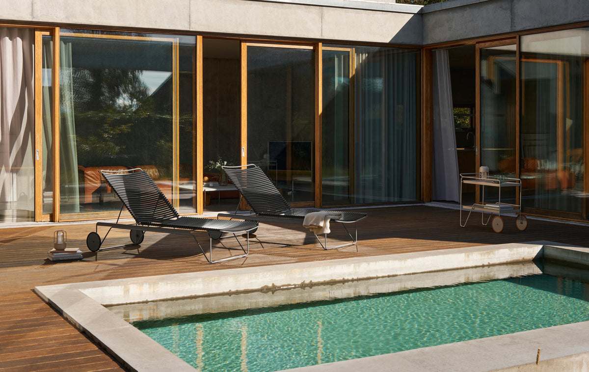 Click Adjustable Chaise Sunlounger by Houe, showing click adjustable chaise sunloungers in live shot.