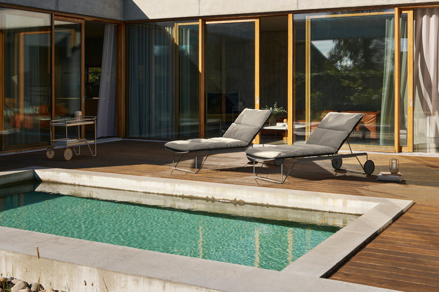 Click Adjustable Chaise Sunlounger by Houe, showing click adjustable chaise sunloungers in live shot.