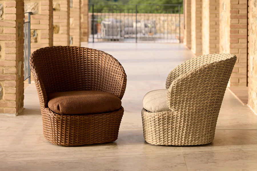Coast Lounge Chair with Swivel by Cane-Line, showing coast lounge chair with swivel in live shot.