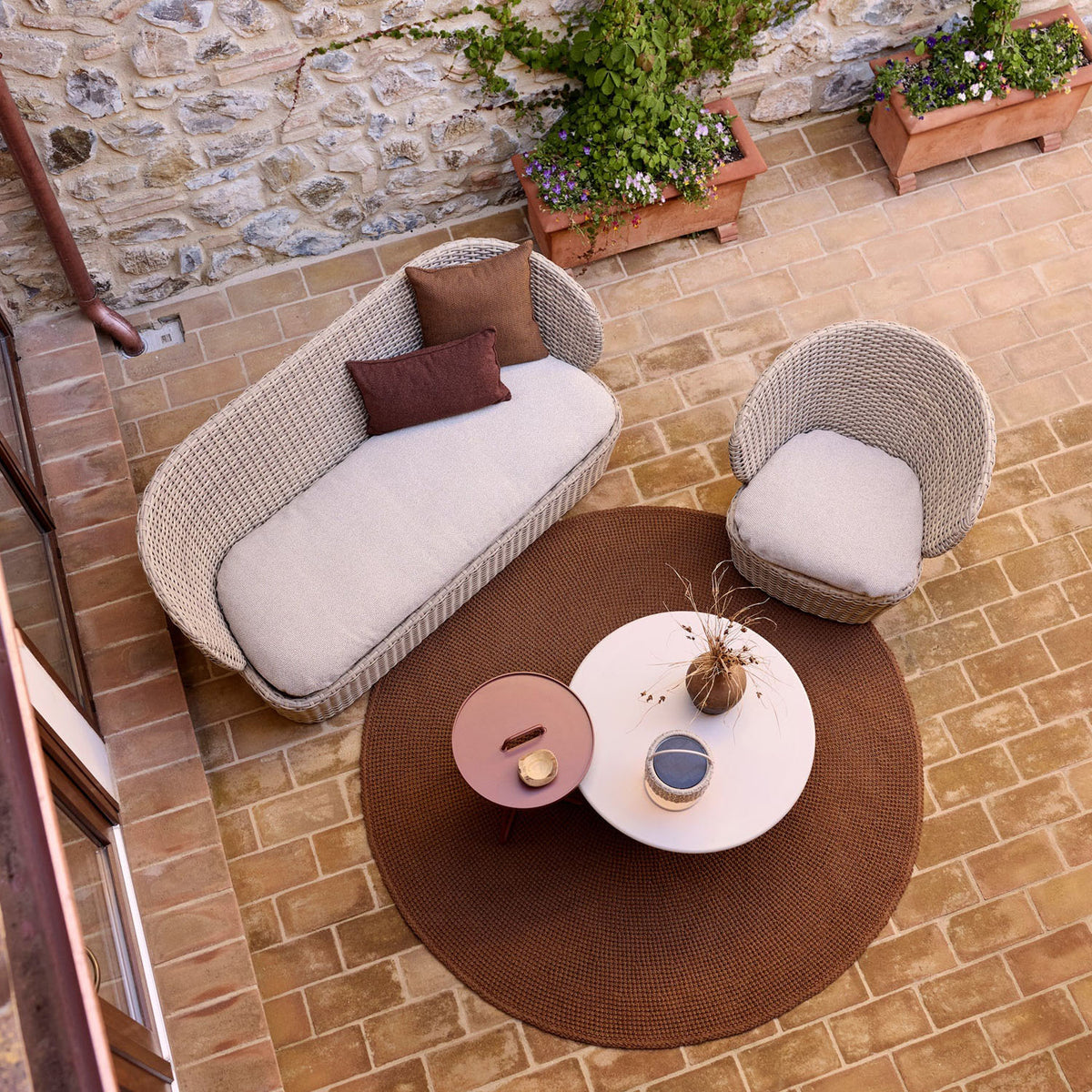 Coast Lounge Chair with Swivel by Cane-Line, showing coast lounge chair with swivel in live shot.