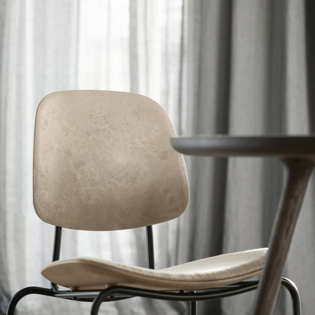 Compound Dining Chair by Mater, showing closeup view of compound dining chair in live shot.