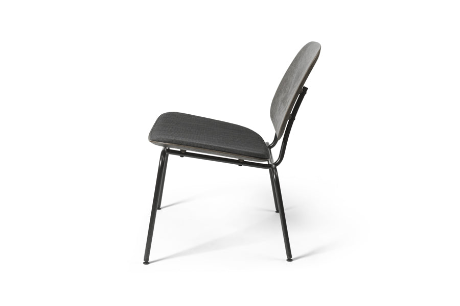 Compound Lounge Chair by Mater, showing side view of compound lounge chair in black coffee waste.