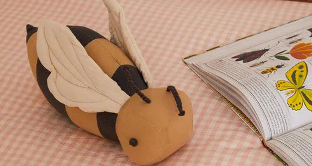 Planet Bee Floor Cushion by Lorena Canals, showing planet bee floor cushion in live shot.