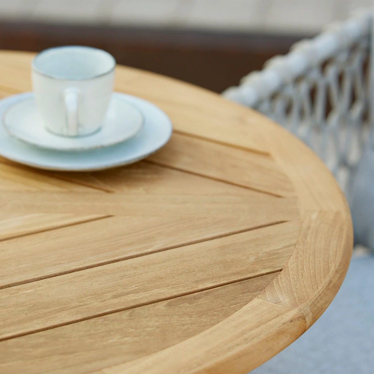 Drop 24" Cafe Table by Cane-Line, showing closeup view of drop 24" cafe table in live shot.