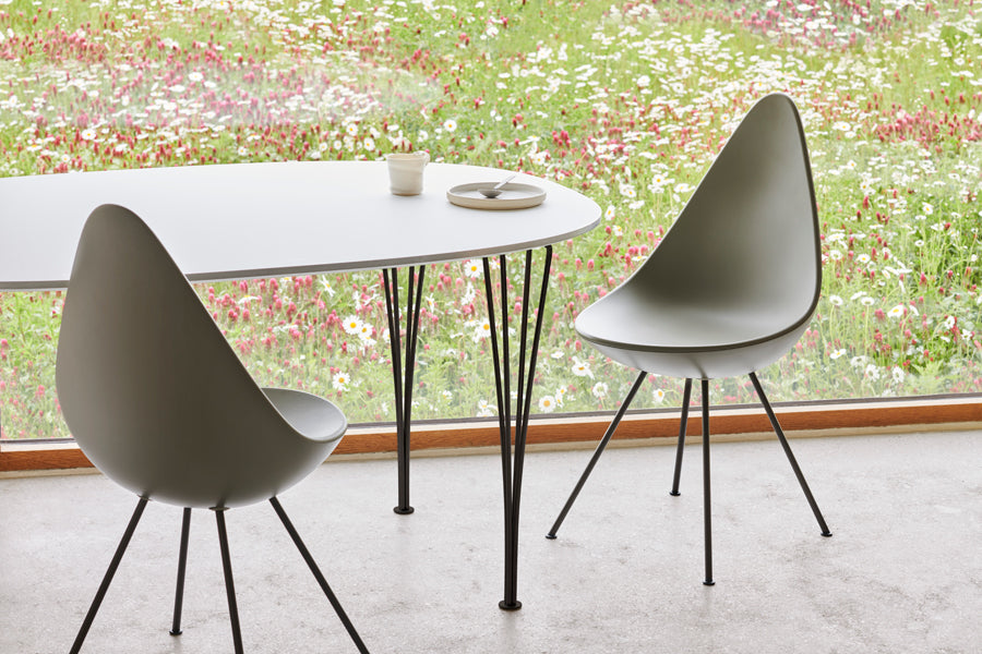Drop Chair by Fritz Hansen, showing drop chairs in live shot.