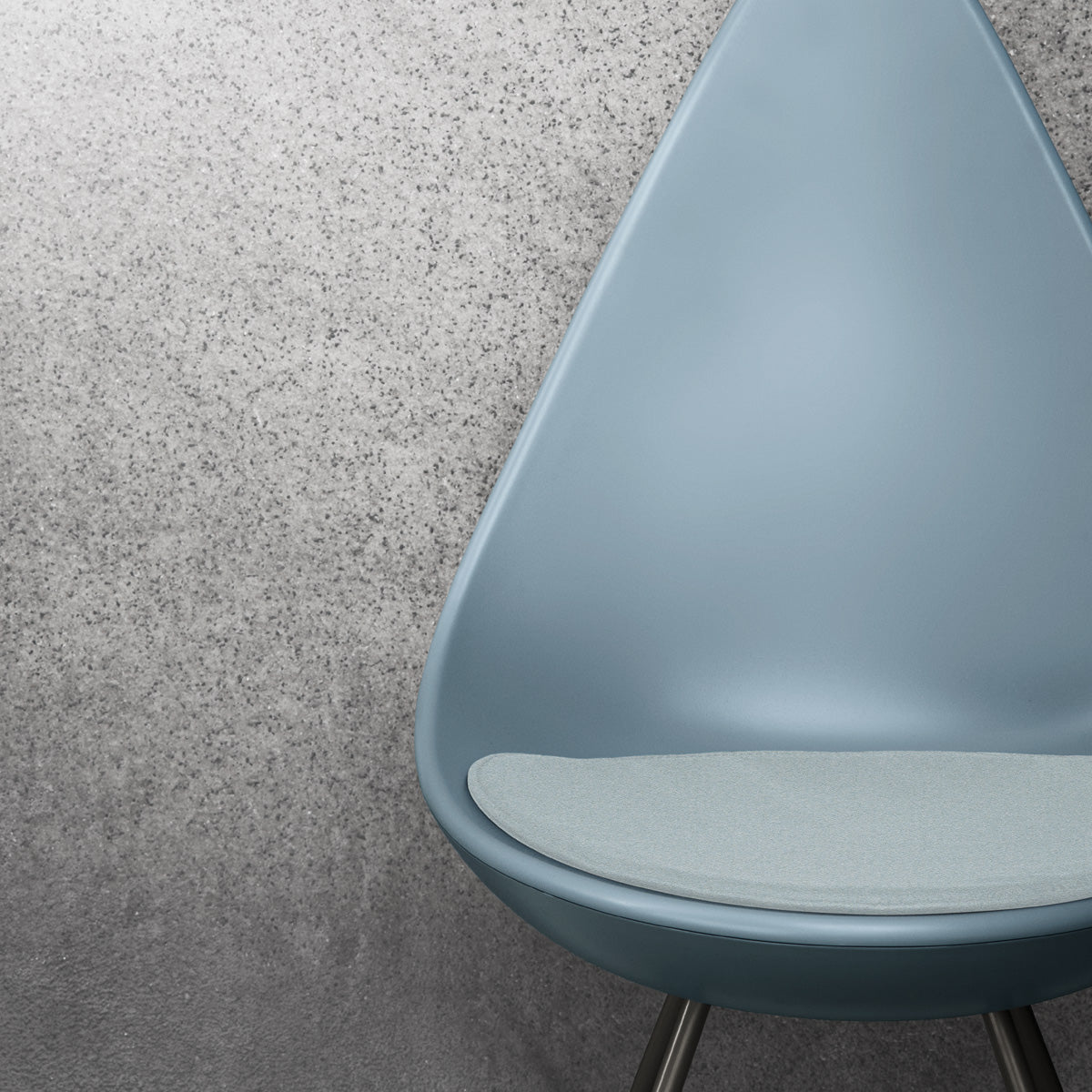 Drop Cushion by Fritz Hansen, showing closeup view of drop cushion with chair in live shot.